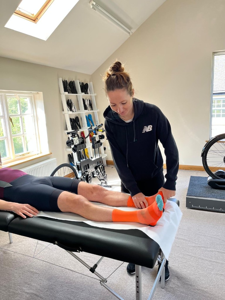 Physiotherapist assessing a rider during a UK Bike Fit session